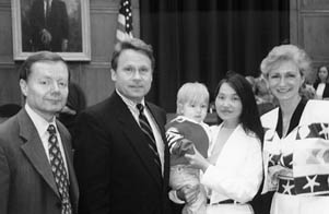 After the hearing, Gary Bauer of the Family Research Council, Congressman Chris Smith, Zhou (holding Caleb Palmquist), and Zhou's 'mom'.